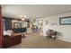 Spacious living room featuring plush carpeting and a large window with natural light at 12101 Riverdale Rd, Brighton, CO 80602