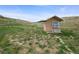 Exterior of a small outbuilding with a hillside landscape at 12101 Riverdale Rd, Brighton, CO 80602