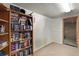 Room with wood bookcase full of books and white walls at 12101 Riverdale Rd, Brighton, CO 80602