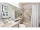 Full bathroom featuring a shower-tub combo with a shower curtain and a tiled wall at 60 S Moline St, Aurora, CO 80012