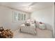 Bright bedroom with white metal bed frame, shutters, and natural light at 60 S Moline St, Aurora, CO 80012