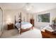 Charming bedroom with a four-poster bed, neutral tones, and a bright window view at 60 S Moline St, Aurora, CO 80012