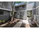 Charming townhome with mature trees, neutral siding, and inviting walkway to the front door at 60 S Moline St, Aurora, CO 80012