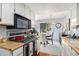 Efficient kitchen leading to dining area with white cabinets and modern appliances at 60 S Moline St, Aurora, CO 80012