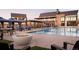 Resort-style community pool area with cabanas, lounge chairs, and a modern fire pit at 619 Scrubjay Cir, Castle Rock, CO 80104