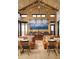 Inviting dining area with wooden floors, brick accent wall, and ample seating at 619 Scrubjay Cir, Castle Rock, CO 80104