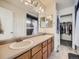 Bright bathroom with double sinks, a large mirror, and a walk-in closet for ample storage at 12682 Kearney St, Thornton, CO 80602