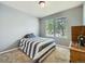 Well-lit bedroom with natural light from two windows and neutral carpet, creating a peaceful space at 12682 Kearney St, Thornton, CO 80602