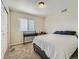 Neutral bedroom with a minimalist desk setup and a large window providing plenty of natural light at 12682 Kearney St, Thornton, CO 80602