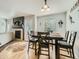 Dining area features a modern table with seating for six, adjacent to a fireplace, and a convenient door to the outside at 12682 Kearney St, Thornton, CO 80602