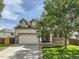 Charming home featuring a two-car garage, well-maintained lawn, and inviting curb appeal on a sunny day at 12682 Kearney St, Thornton, CO 80602