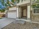 Inviting covered front porch leads to the front door, complemented by a well-maintained garage and stone accents at 12682 Kearney St, Thornton, CO 80602