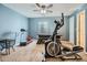 Home gym with various exercise equipment including an elliptical, treadmill, and air hockey table at 12682 Kearney St, Thornton, CO 80602