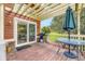 Charming back deck with a dining area, sliding doors, grill, and tranquil backyard views at 19440 E Mann Creek Dr # E, Parker, CO 80134