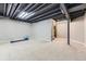 Spacious carpeted basement with open ceiling, ideal for a home gym or recreation area at 19440 E Mann Creek Dr # E, Parker, CO 80134