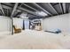 Finished basement space with carpet flooring, exposed ceiling, guitar, and workout equipment at 19440 E Mann Creek Dr # E, Parker, CO 80134