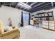 Finished basement with an open ceiling, music listening station, a comfy chair, and natural light at 19440 E Mann Creek Dr # E, Parker, CO 80134