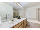 Spacious bathroom features double sinks, large vanity, a soaking tub and glass-enclosed shower stall at 19440 E Mann Creek Dr # E, Parker, CO 80134