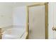 Bathroom featuring a shower with glass door, soaking tub and a neutral color palette at 19440 E Mann Creek Dr # E, Parker, CO 80134
