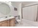 Well-lit bathroom features a single sink, toilet, tub, shower with white tile and marble countertop at 19440 E Mann Creek Dr # E, Parker, CO 80134