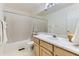 Bright bathroom features a single sink vanity, large mirror and shower-tub combination at 19440 E Mann Creek Dr # E, Parker, CO 80134