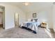 Vaulted ceiling bedroom offers natural light, comfortable bed, and a doorway to the attached bathroom at 19440 E Mann Creek Dr # E, Parker, CO 80134