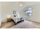 Bright bedroom with vaulted ceiling, ceiling fan, a comfortable bed and large window with neighborhood view at 19440 E Mann Creek Dr # E, Parker, CO 80134
