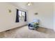 Bright bedroom featuring neutral walls, plush carpet, window, and a whimsical cartoon wall art at 19440 E Mann Creek Dr # E, Parker, CO 80134