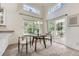 Bright dining area with large windows, sliding door to deck, and contemporary-style table and chairs at 19440 E Mann Creek Dr # E, Parker, CO 80134
