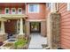 Inviting townhome exterior with brick pillars, covered entrances, and homey welcome decor at 19440 E Mann Creek Dr # E, Parker, CO 80134