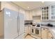Kitchen with white cabinetry, granite counters, gas range, and a large Samsung stainless steel refrigerator at 19440 E Mann Creek Dr # E, Parker, CO 80134