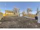 Spacious backyard with wooden fence, shed, and steps leading up at 1840 S Shoshone St, Denver, CO 80223