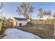 Backyard with shed, wooden fence, and a partially visible home at 1840 S Shoshone St, Denver, CO 80223