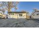 Charming single story home with a well-manicured lawn and updated facade at 1840 S Shoshone St, Denver, CO 80223