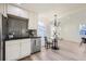 Modern kitchen with stainless steel appliances and a dining area at 1840 S Shoshone St, Denver, CO 80223