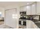 Kitchen features stainless steel appliances and white cabinets at 1840 S Shoshone St, Denver, CO 80223