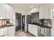 Modern kitchen with stainless steel appliances and white cabinets at 1840 S Shoshone St, Denver, CO 80223