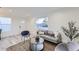 Open living area with gray couch and large window overlooking street at 1840 S Shoshone St, Denver, CO 80223