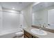 Bathroom featuring a tub with white tiled walls and a white basin sink at 1418 Hudson Pl, Longmont, CO 80501