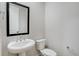 Half bathroom featuring a modern sink and toilet at 1418 Hudson Pl, Longmont, CO 80501