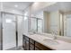 Bathroom with double sinks, a walk-in shower, and white subway tile at 1418 Hudson Pl, Longmont, CO 80501