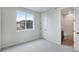 Bright bedroom with ensuite bathroom offers natural light and a neutral color palette at 1418 Hudson Pl, Longmont, CO 80501