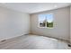 Light-filled bedroom offers a large window overlooking trees at 1418 Hudson Pl, Longmont, CO 80501