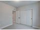 Bright bedroom with light gray carpet, featuring a closet with three doors at 1418 Hudson Pl, Longmont, CO 80501