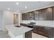 Modern kitchen with a large island, stainless appliances, and dark cabinets at 1418 Hudson Pl, Longmont, CO 80501