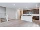 Open-concept kitchen featuring a center island, modern appliances, and dark wood cabinetry at 1418 Hudson Pl, Longmont, CO 80501