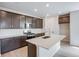 Modern kitchen features dark cabinets and an island with quartz countertops at 1418 Hudson Pl, Longmont, CO 80501