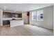 Open kitchen features dark cabinets, island with seating, and stainless appliances at 1418 Hudson Pl, Longmont, CO 80501