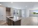 Modern kitchen featuring a large island with a sink and open floor plan at 1418 Hudson Pl, Longmont, CO 80501