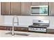 Close-up of kitchen with stainless steel appliances and stylish cabinetry at 1418 Hudson Pl, Longmont, CO 80501
